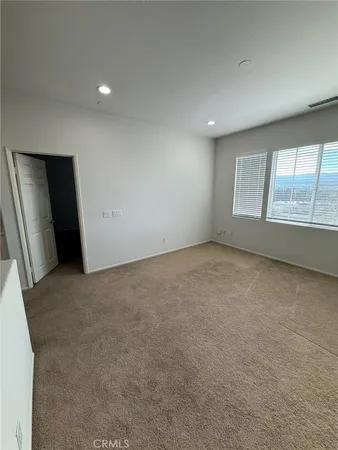 a spacious bathroom with a double vanity sink a mirror and a shower