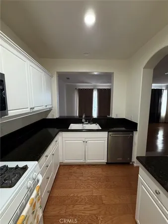 a view of an empty room with a fireplace and a window
