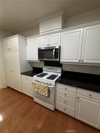 a view of kitchen with stainless steel appliances granite countertop refrigerator sink and stove