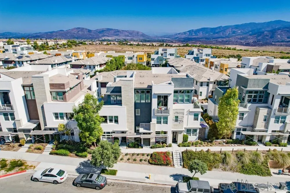 a view of multiple houses with a yard