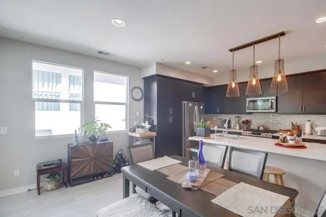 a kitchen with a sink a stove and chairs