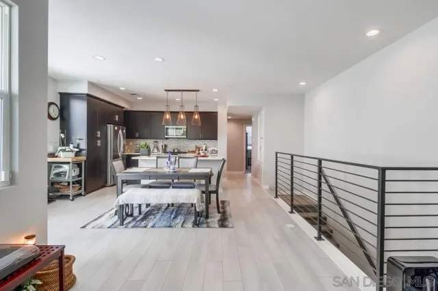 a living room with furniture and kitchen view