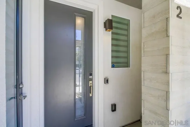 a view of a hallway with wooden floor and entryway
