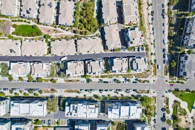 an aerial view of residential houses with outdoor space