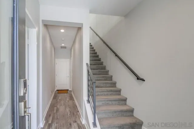 a view of entryway with stairs and wooden floor