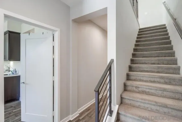 a dining room with furniture a chandelier and wooden floor