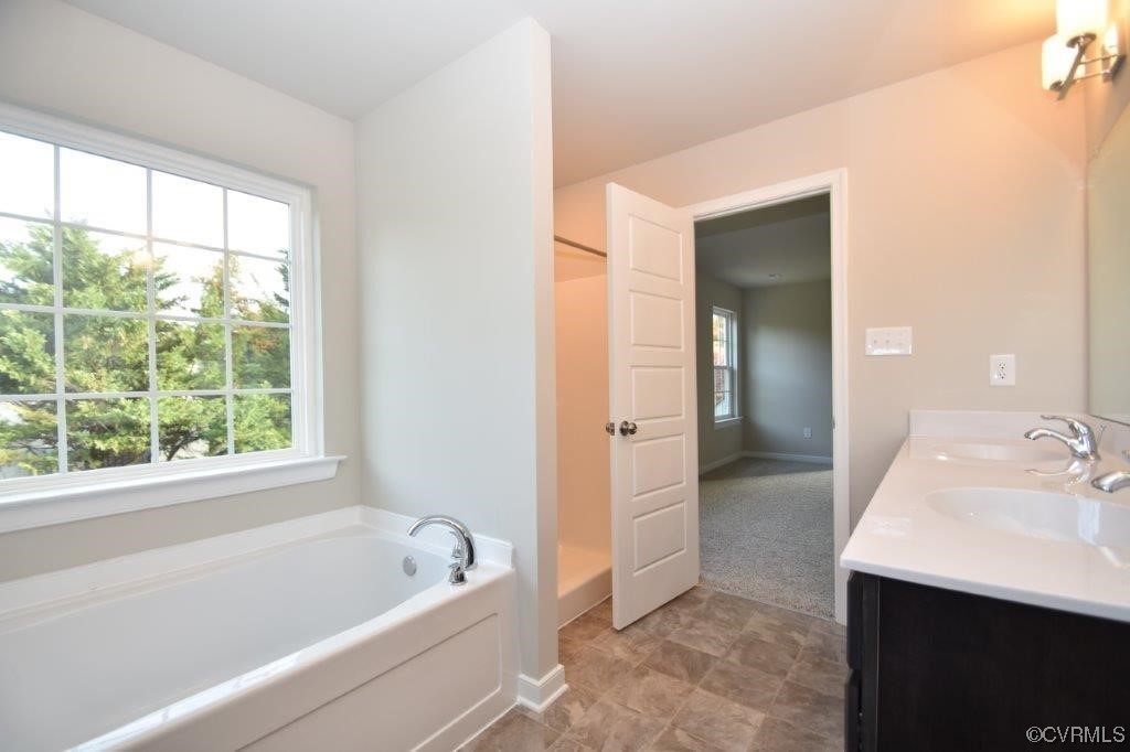 2 Brook Boulevard Quinton, VA 23141 - Photo 11 of 16 a bathroom with a tub sink and mirror
