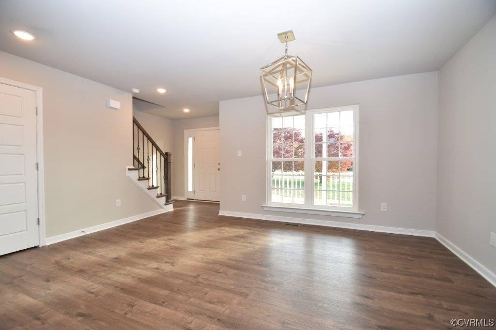 2 Brook Boulevard Quinton, VA 23141 - Photo 3 of 16 an empty room with wooden floor and chandelier