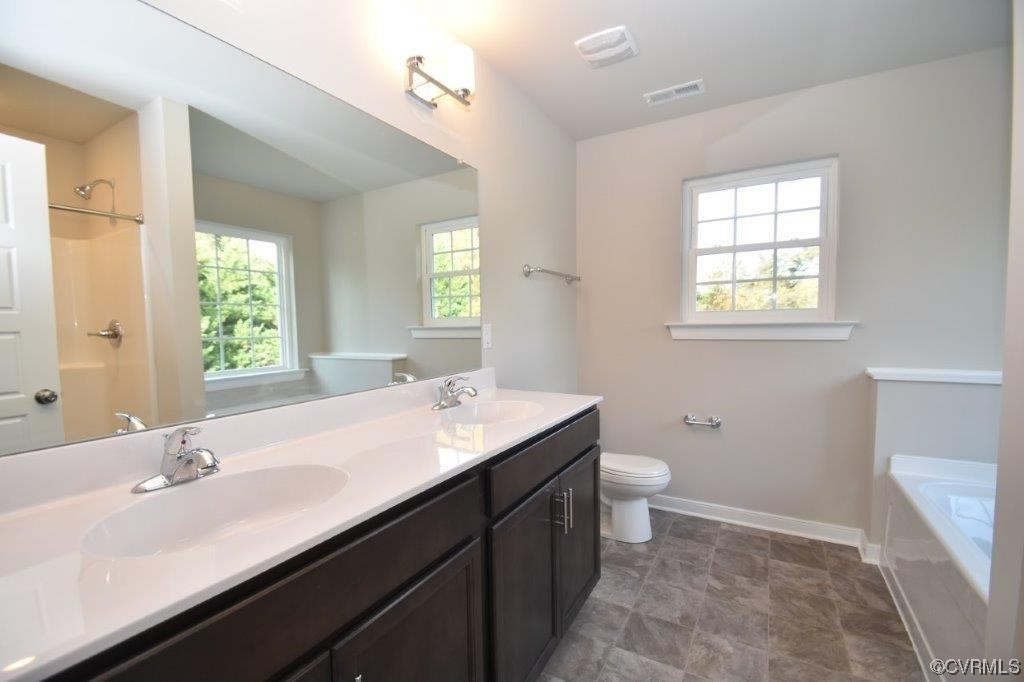 2 Brook Boulevard Quinton, VA 23141 - Photo 10 of 16 a bathroom with a double vanity sink toilet and a mirror