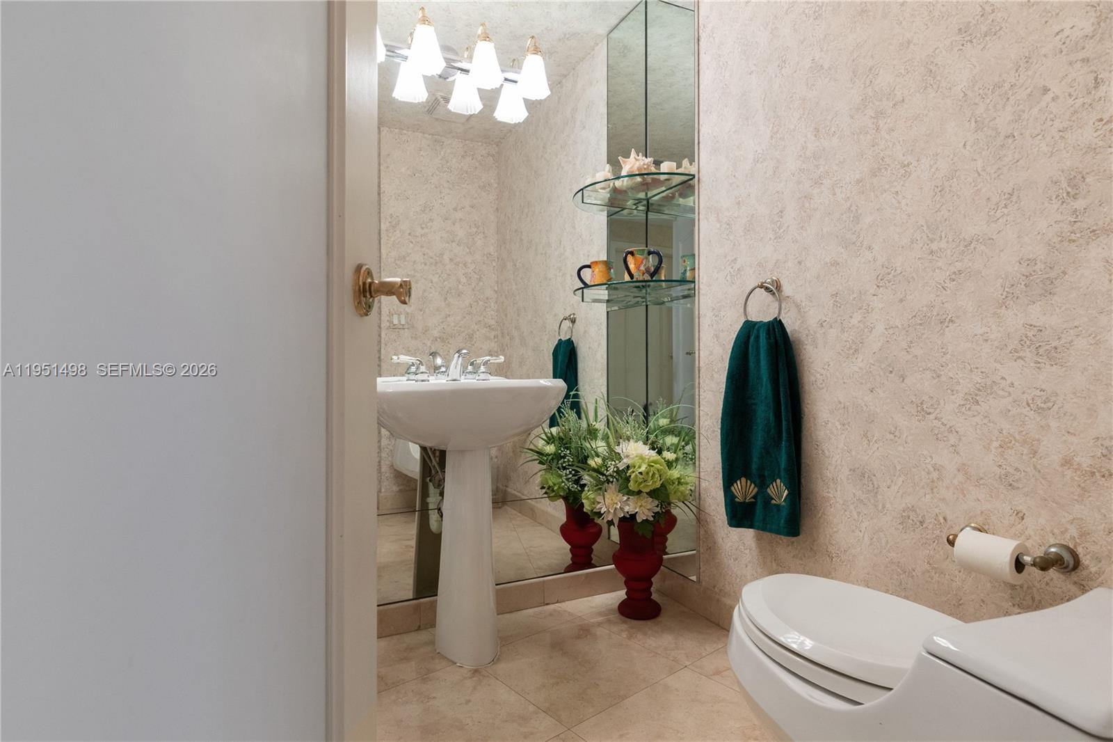 9601 Collins Avenue, Unit 507 Bal Harbour, FL 33154 - Photo 24 of 40 a bathroom with a sink a toilet and a mirror