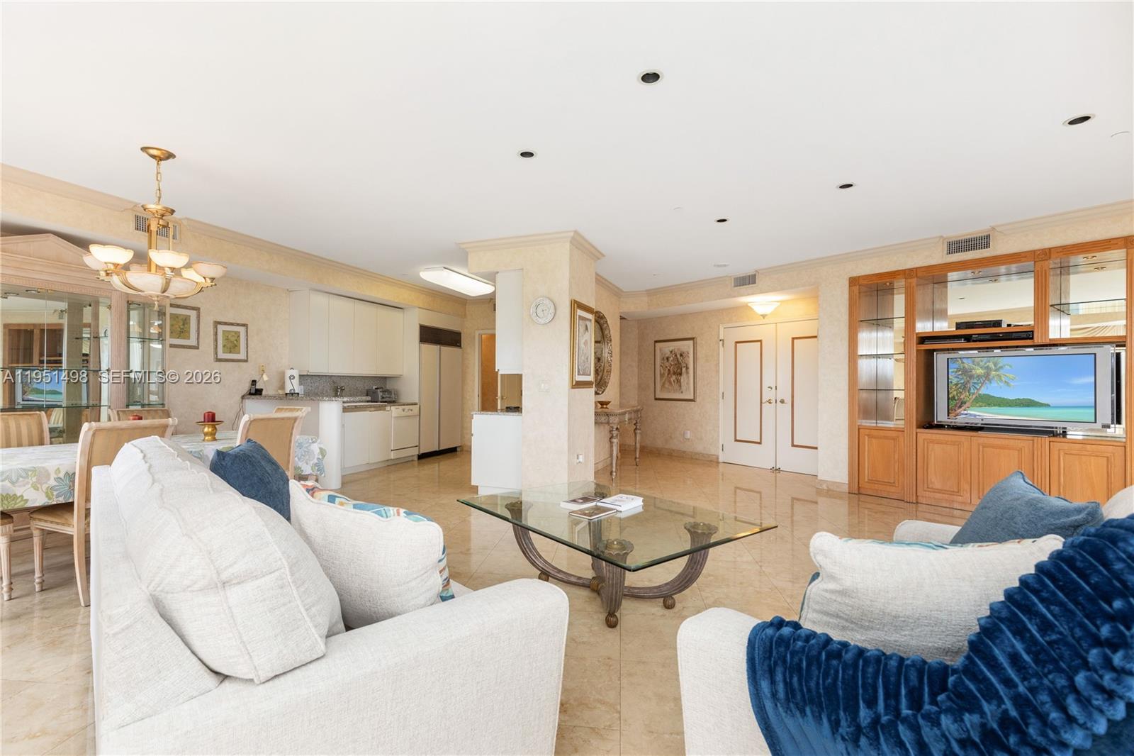 9601 Collins Avenue, Unit 507 Bal Harbour, FL 33154 - Photo 7 of 40 a living room with furniture kitchen view and a chandelier