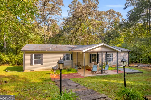 a view of a house with a yard patio and swimming pool