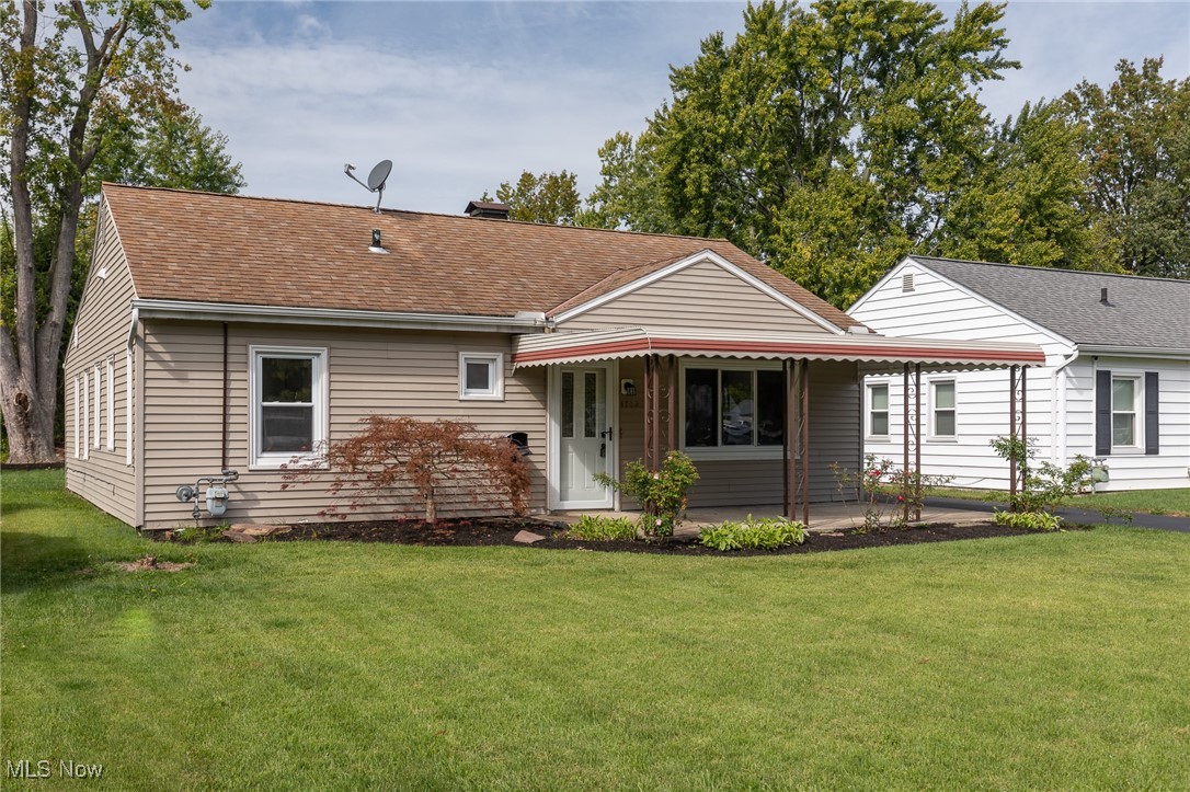 4782 Belle Meadow Road Mentor, OH 44060 - Photo 2 of 22 Back of house with a lawn and covered porch