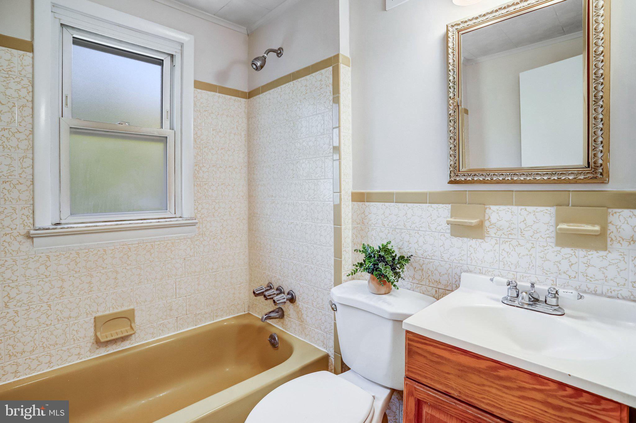 616 Ritchie Avenue Silver Spring, MD 20910 - Photo 18 of 37 a bathroom with a sink a mirror and a bathtub