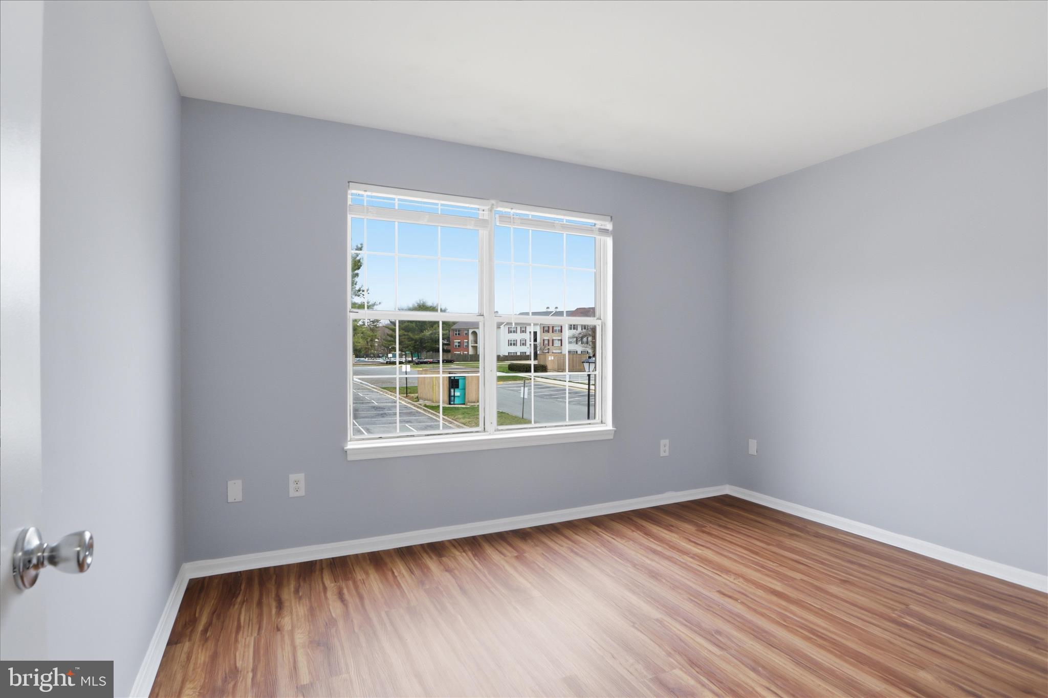 14913 Cleese Court, Unit C Silver Spring, MD 20906 - Photo 17 of 35 an empty room with wooden floor and windows