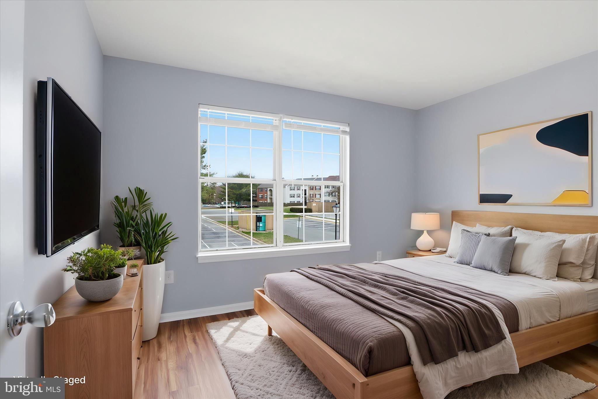 14913 Cleese Court, Unit C Silver Spring, MD 20906 - Photo 18 of 35 a bedroom with a large bed and a potted plant