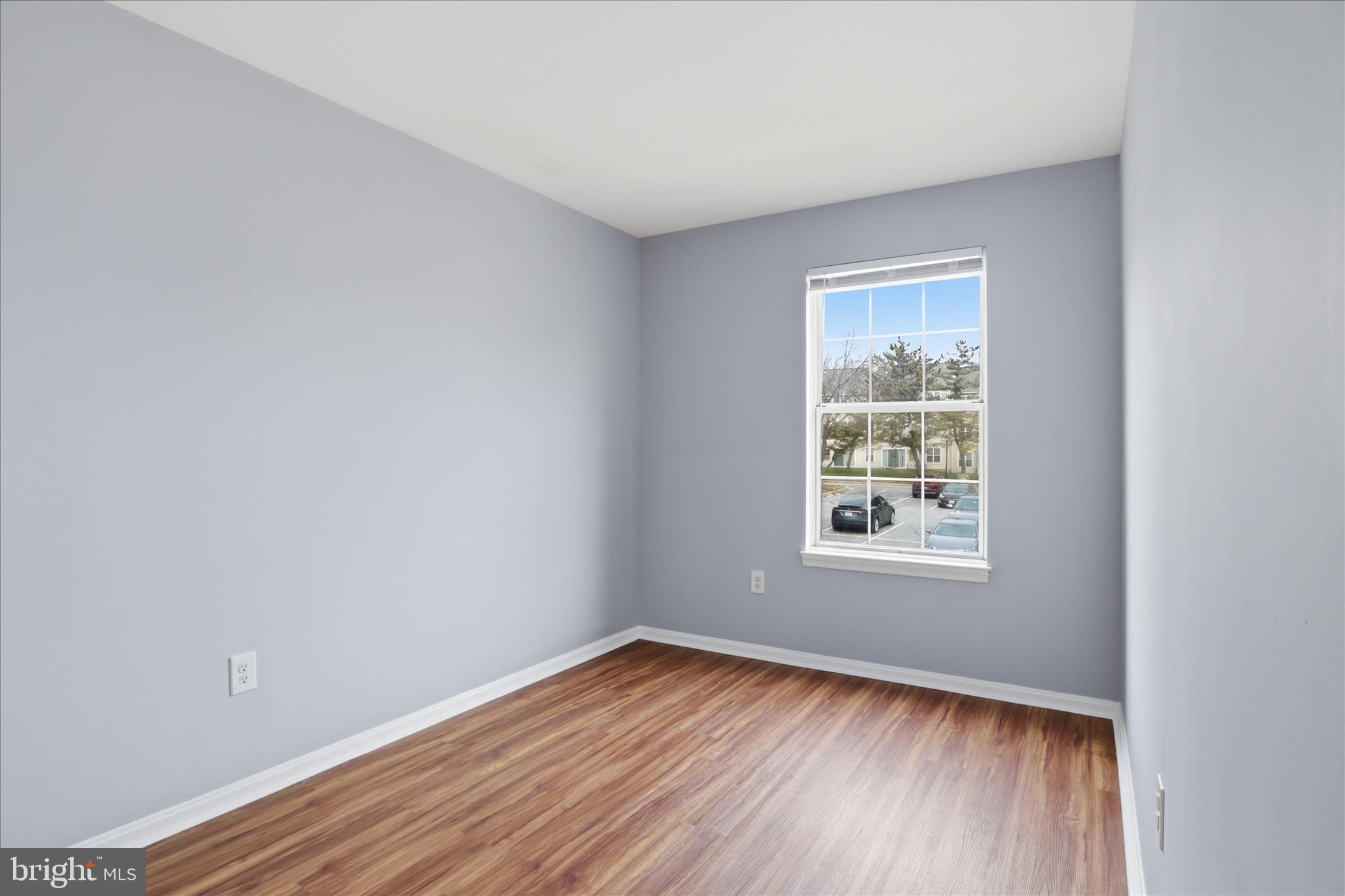 14913 Cleese Court, Unit C Silver Spring, MD 20906 - Photo 20 of 35 an empty room with wooden floor and windows