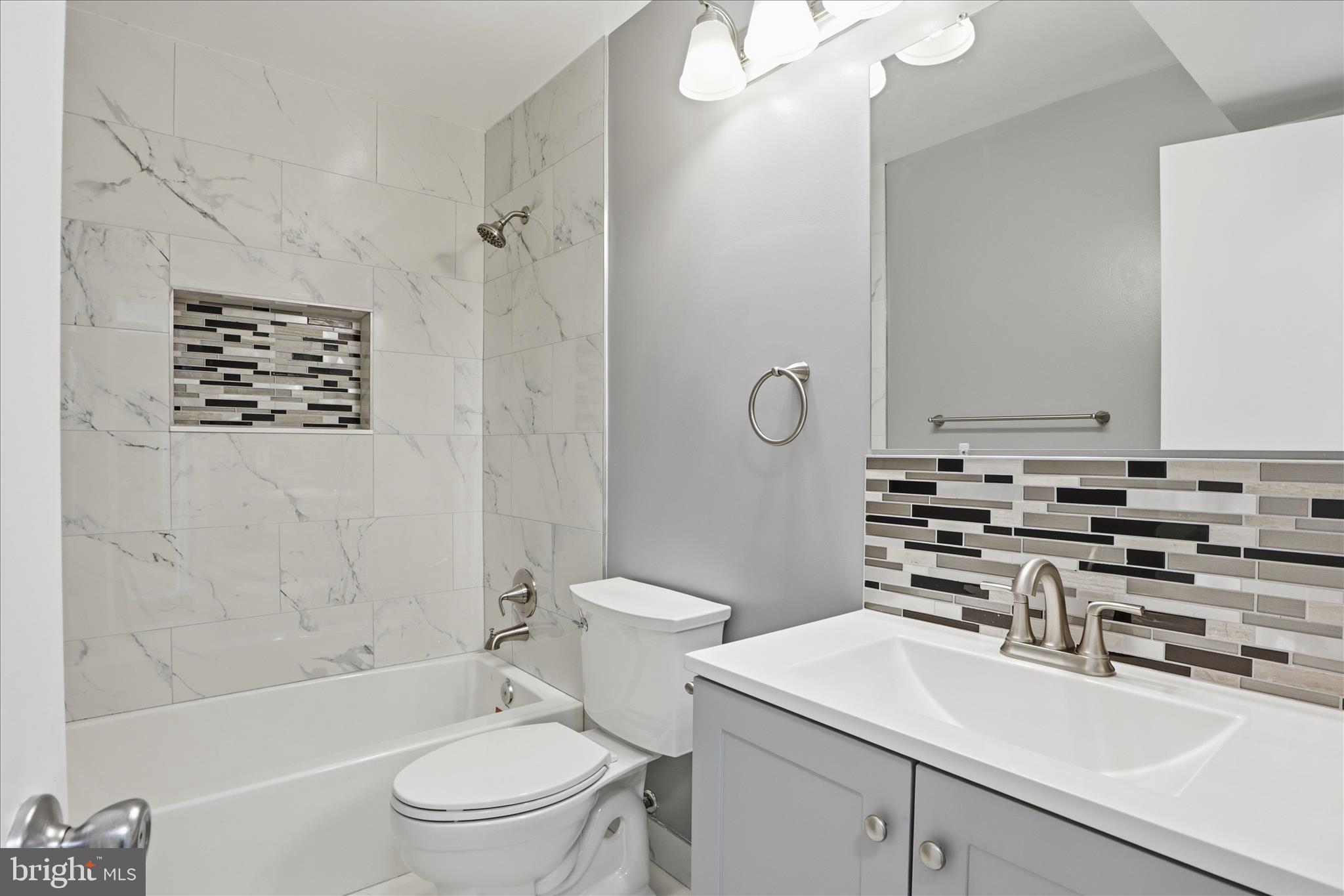 14913 Cleese Court, Unit C Silver Spring, MD 20906 - Photo 23 of 35 a bathroom with a sink a toilet a mirror and shower