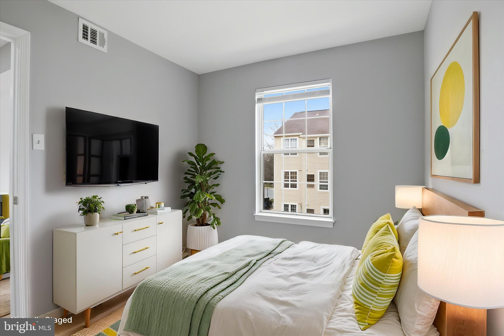 14913 Cleese Court, Unit C Silver Spring, MD 20906 - Photo 10 of 35 a bedroom with a bed and a flat screen tv