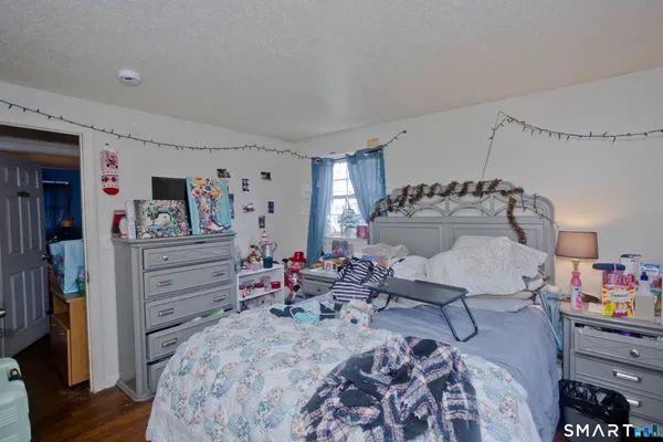 a bed room with a bed and a tv on the dresser
