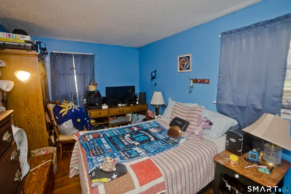a bed room with a bed and a chair