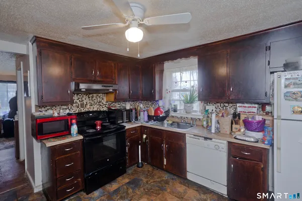 a kitchen with a refrigerator and a stove top oven