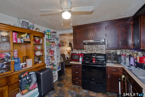 a kitchen with stainless steel appliances granite countertop a refrigerator and stove top oven