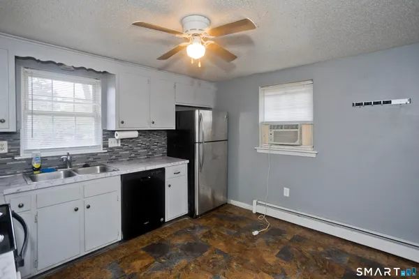 a kitchen with a sink stove and refrigerator