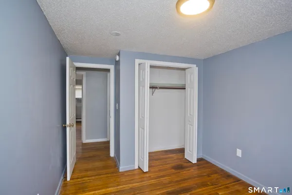 a view of a room with wooden floor