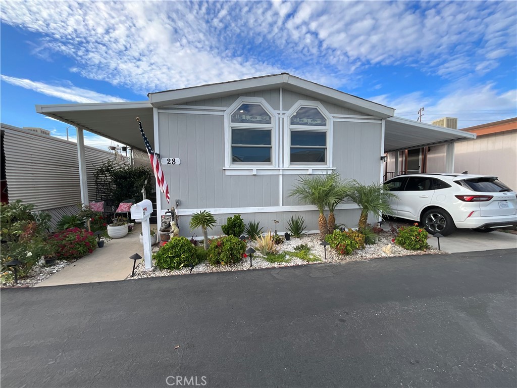15621 Beach Boulevard, Unit 28 Huntington Beach, CA 92647 - Photo 1 of 27 a front view of a house with a yard