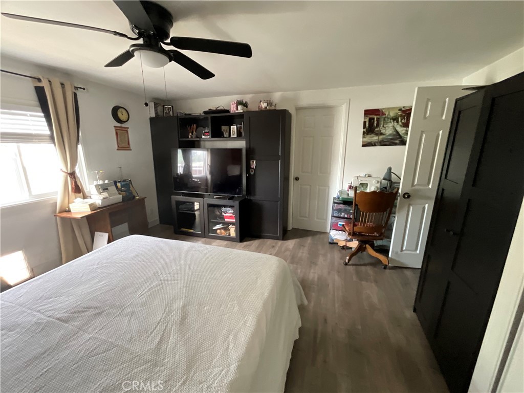 15621 Beach Boulevard, Unit 28 Huntington Beach, CA 92647 - Photo 11 of 27 a bed room with a bed tv and a window