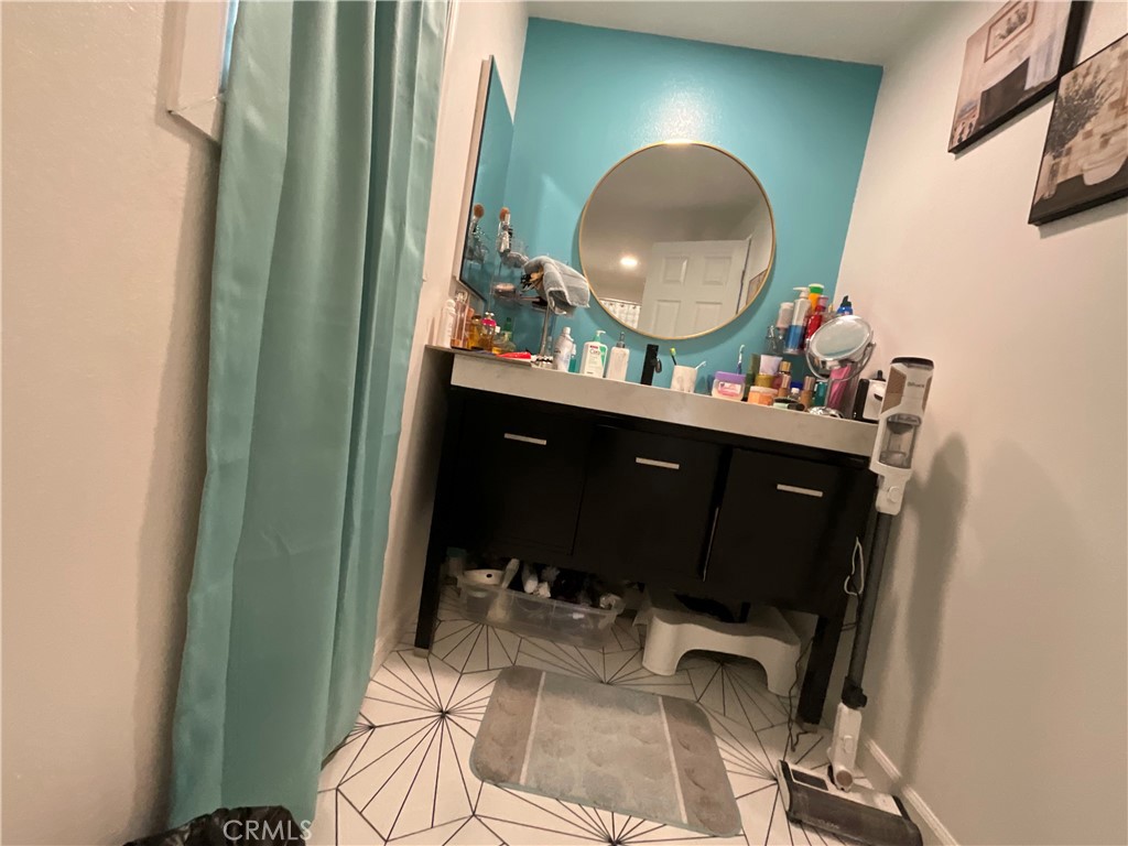 15621 Beach Boulevard, Unit 28 Huntington Beach, CA 92647 - Photo 13 of 27 a living room with a mirror and a wooden floor