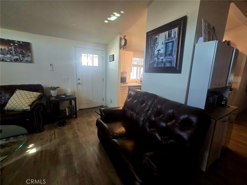 15621 Beach Boulevard, Unit 28 Huntington Beach, CA 92647 - Photo 17 of 27 a living room with furniture and a mirror