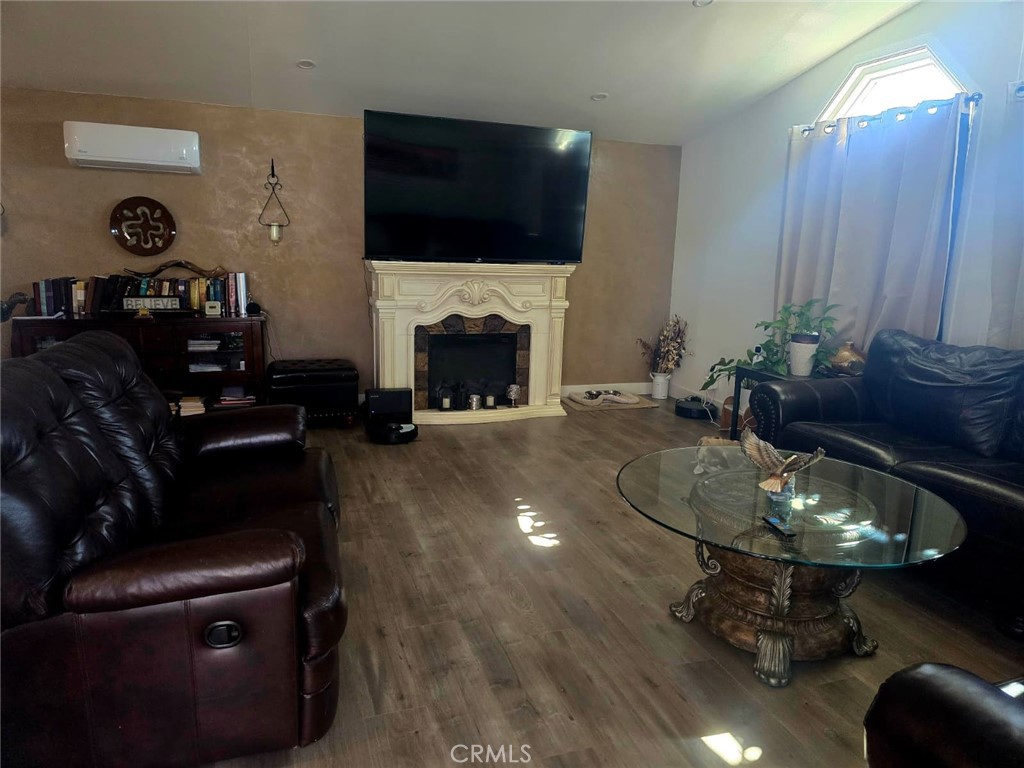 15621 Beach Boulevard, Unit 28 Huntington Beach, CA 92647 - Photo 19 of 27 a living room with furniture a flat screen tv and a fireplace