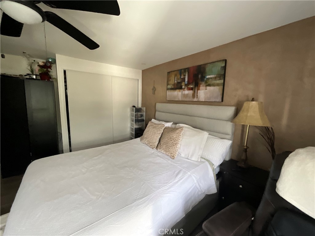 15621 Beach Boulevard, Unit 28 Huntington Beach, CA 92647 - Photo 10 of 27 a bedroom with a bed and a painting on the wall