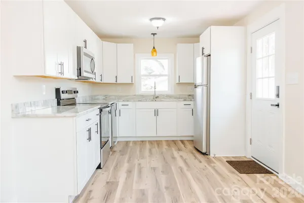a kitchen with a granite countertop sink and window