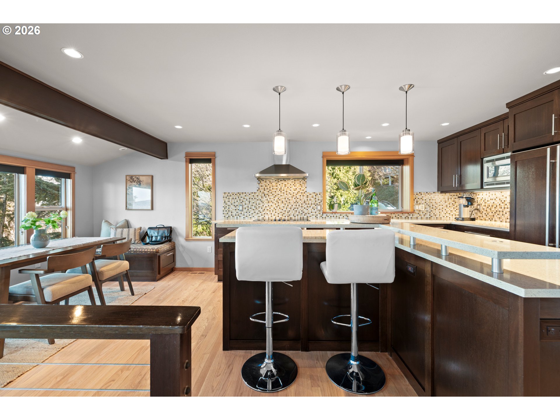 2831 Northeast Rocky Butte Road Portland, OR 97220 - Photo 13 of 33 a kitchen with stainless steel appliances kitchen island granite countertop a table chairs and a refrigerator