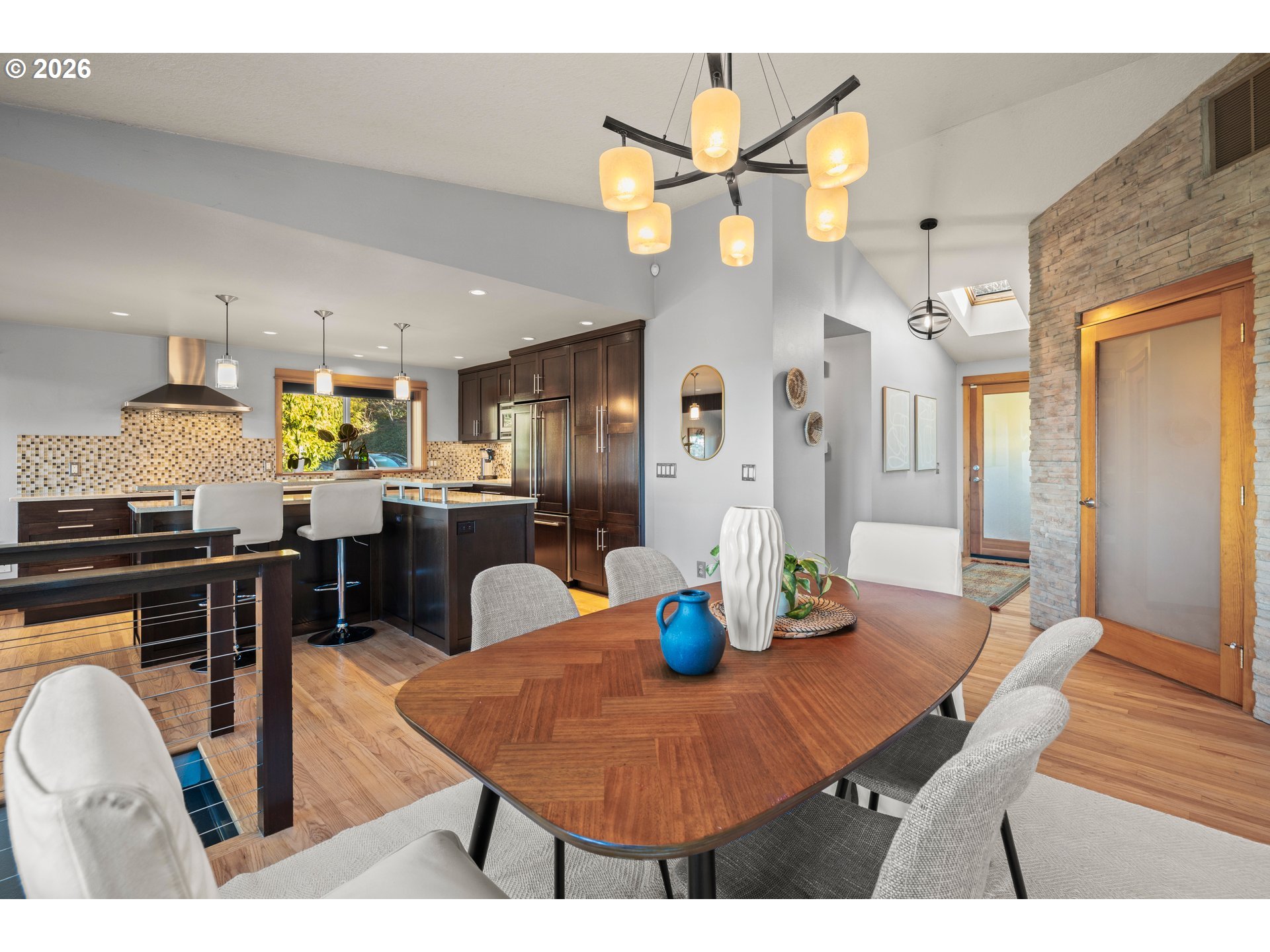 2831 Northeast Rocky Butte Road Portland, OR 97220 - Photo 14 of 33 a dining room filled chandelier and wooden floor