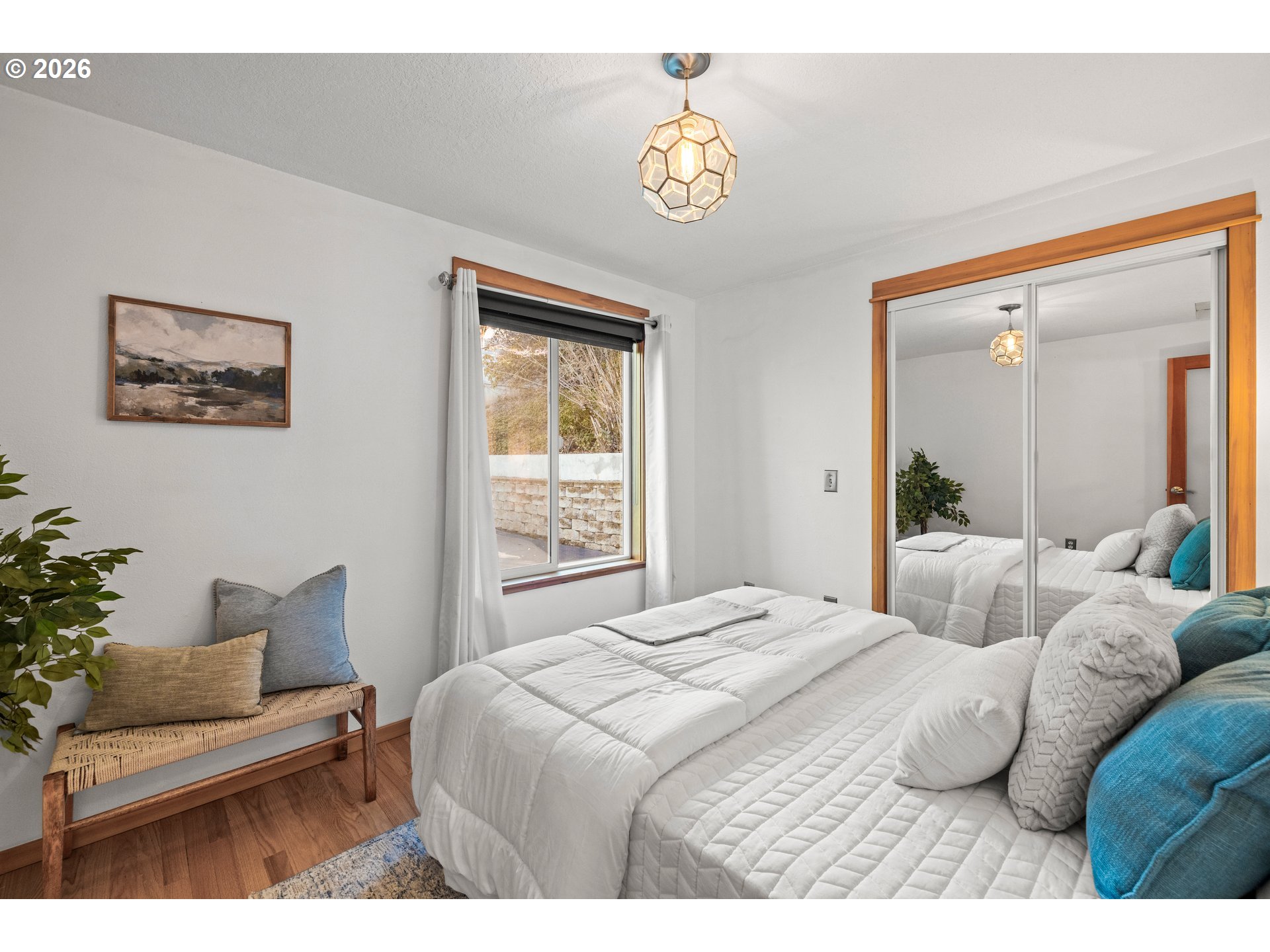 2831 Northeast Rocky Butte Road Portland, OR 97220 - Photo 21 of 33 a bedroom with a bed and a potted plant