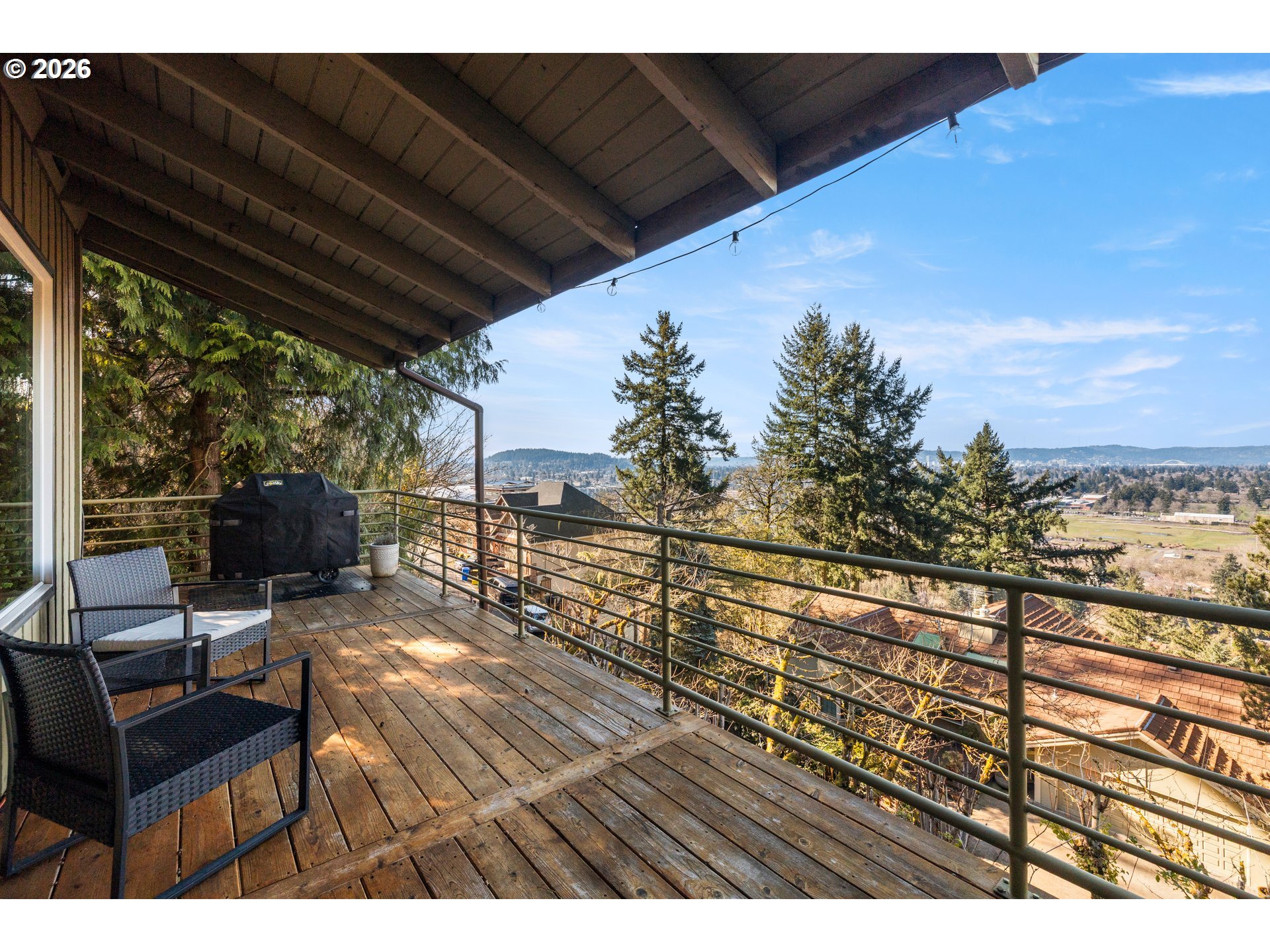 2831 Northeast Rocky Butte Road Portland, OR 97220 - Photo 27 of 33 a view of a balcony with chairs and wooden floor