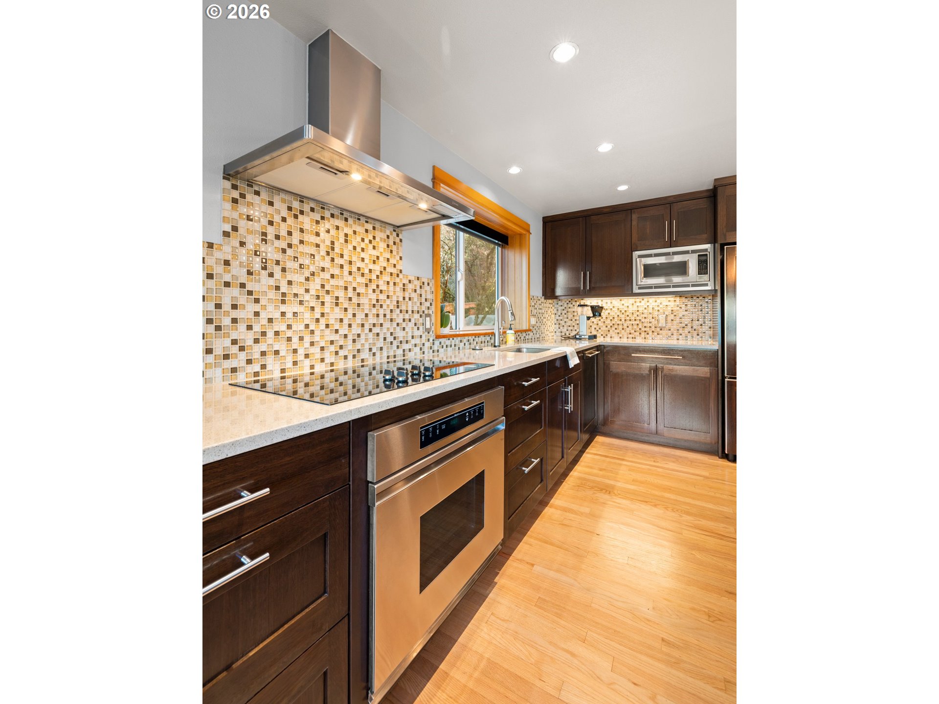 2831 Northeast Rocky Butte Road Portland, OR 97220 - Photo 10 of 33 a kitchen with stainless steel appliances granite countertop a sink and stove top oven