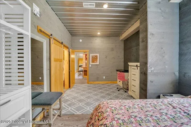 a bedroom with a bed dresser and a large mirror