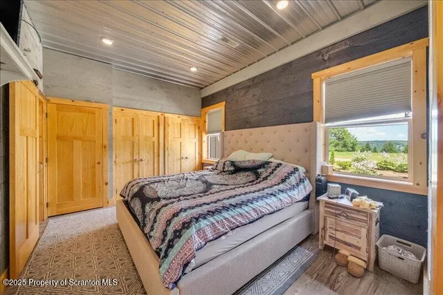 a bed sitting in a spacious bedroom next to a window