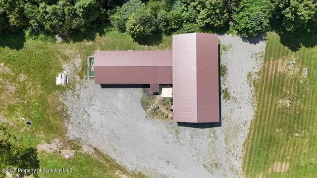 an aerial view of a house with a garden