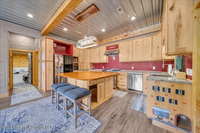 a kitchen with stainless steel appliances granite countertop a sink and cabinets