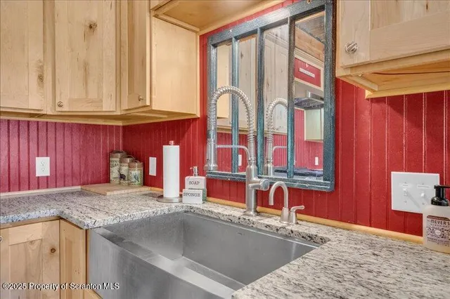 a kitchen with stainless steel appliances granite countertop a sink and cabinets