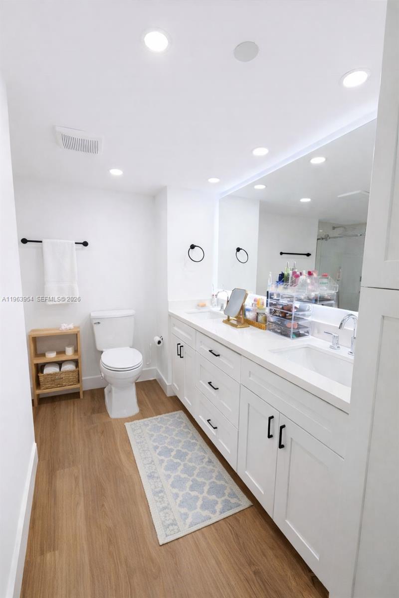 1541 Brickell Avenue, Unit B1504 Miami, FL 33129 - Photo 16 of 31 a bathroom with a sink a toilet and a mirror