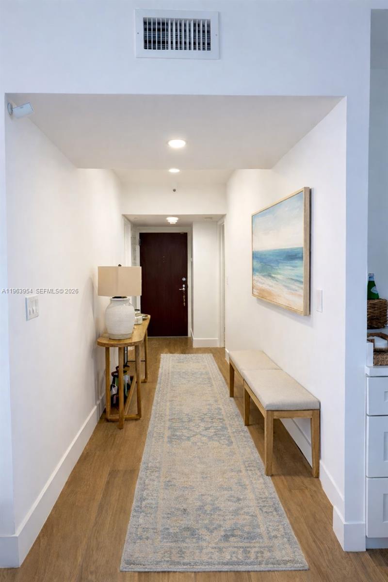1541 Brickell Avenue, Unit B1504 Miami, FL 33129 - Photo 5 of 31 a view of a hallway with wooden floor and furniture