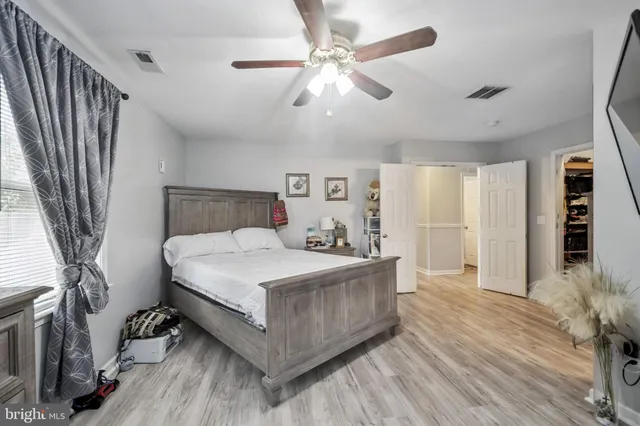 a bed room with a bed and a chandelier