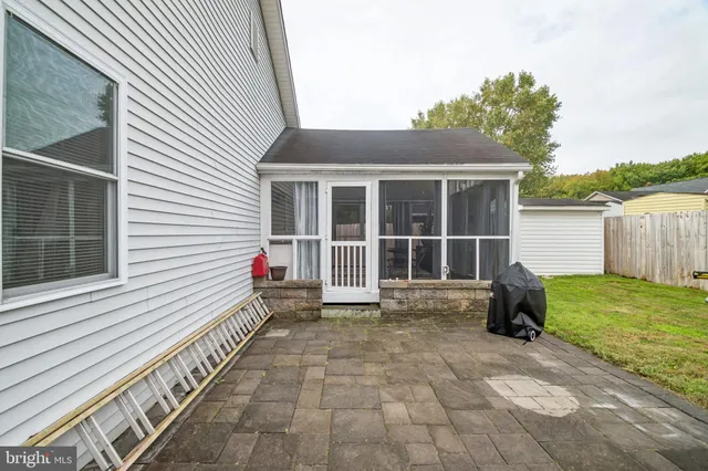 a view of a house with backyard and porch